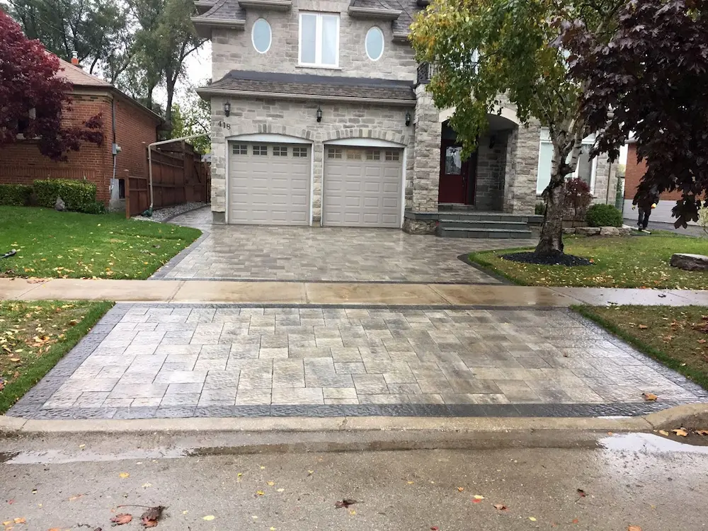 Interlocking stone driveway in front of a residential home, image by oakshs.ca