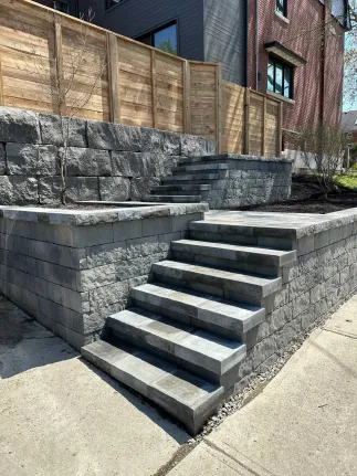 interlocking stone steps with retaining wall and tiered landscape design in residential yard