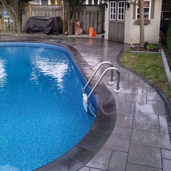 Interlocking pool deck with curved coping and modern stone finish