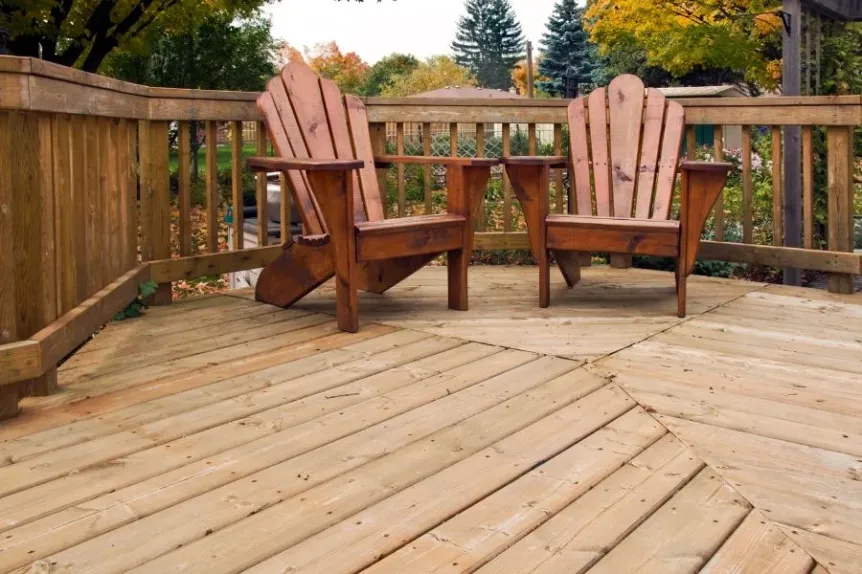 Wood deck with Adirondack chairs and classic railing detail