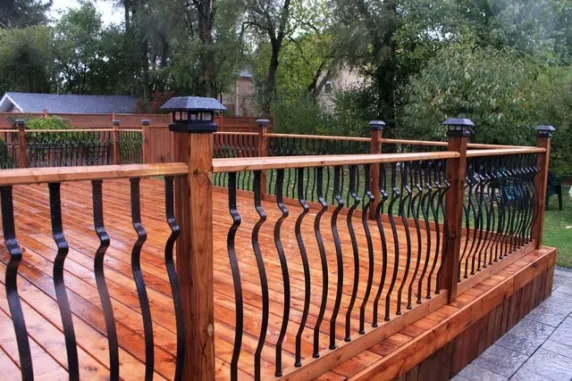 Toronto wooden deck with modern black metal railing and custom deck construction design