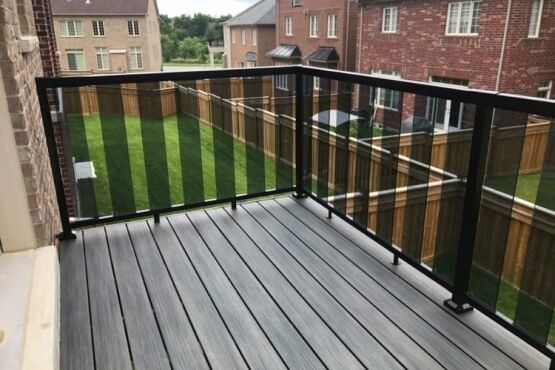 Deck builders in Toronto Balcony railing installation with black-framed glass panels, image by Oaks Home Services