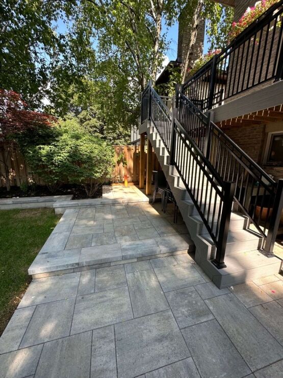 Backyard Walkway With Interlocking Stone Step railing near interlock pavers and outdoor seating, image by Oaks Home Services