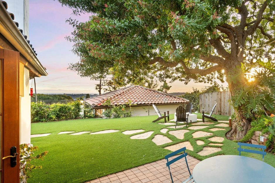 Outdoor garden space by Oaks with lawn and stepping stone path