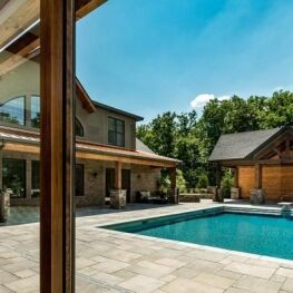 Interlock pool patio with light grey rectangular pavers, photo by Oaks Home Services