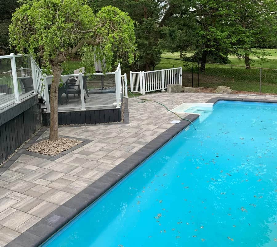 patio-interlocking-uxbridge-1 Backyard pool interlocking with raised patio and modern paver layout, photo by Oaks Home Services