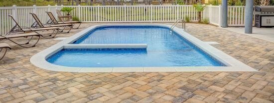 pool-interlocking-2 Pool interlock pavers in light beige laid in herringbone style, photo by Oaks Home Services
