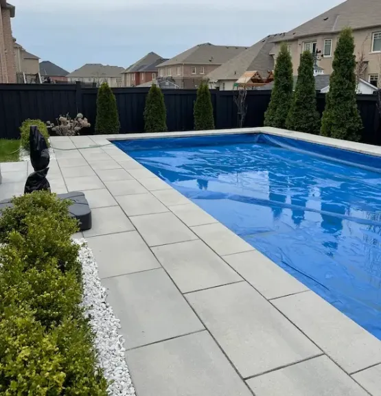 Custom concrete pool with stone patio in Toronto, image by oakshs.ca