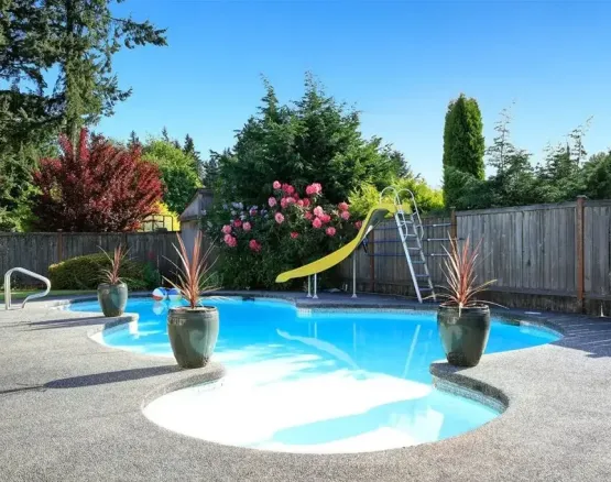 Luxury backyard swimming pool with slide, image by oakshs.ca