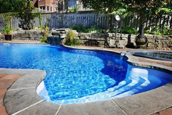 Backyard pool with waterfall and landscaping, image by oakshs.ca