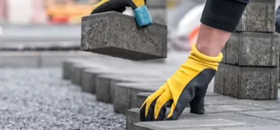 Interlocking pavers installation process on prepared base, image by oakshs.ca
