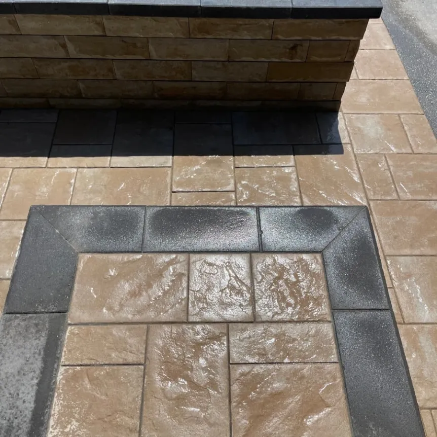 Close-up of interlocking stone patio with textured pavers and contrasting border detail