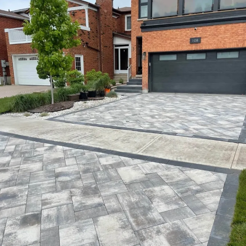 Modern interlocking stone driveway with large format pavers and contrasting border design