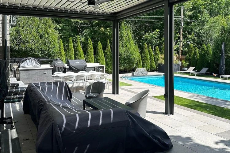 Covered interlocking patio beside pool creating a functional year-round outdoor living space