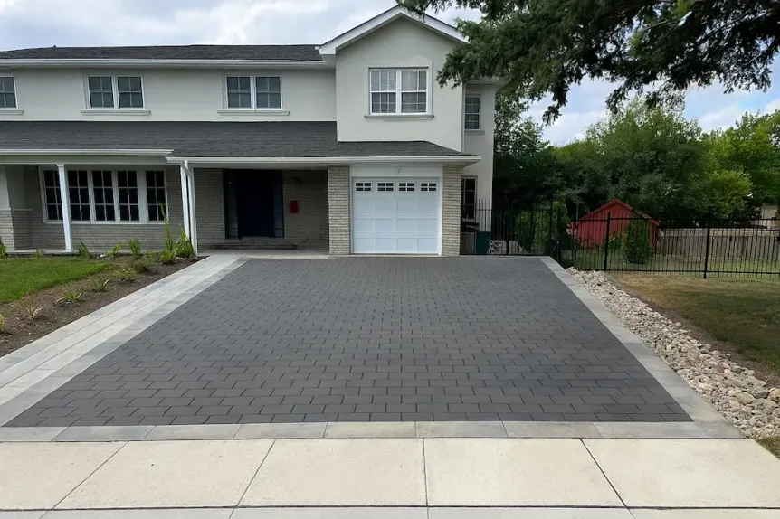 Dark grey interlock driveway with light border accents in Toronto suburban home