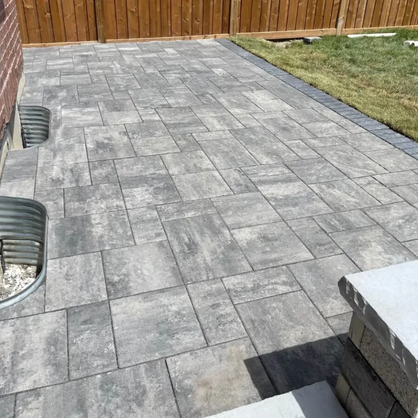 Interlocking stone patio installation with grey pavers and clean modern layout