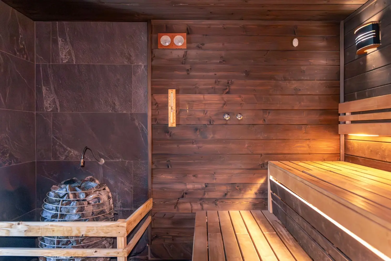 Traditional sauna with an electric stone heater and wooden benches, photo by Oaks