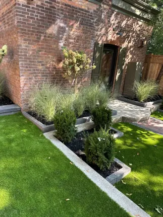 front yard landscape design with raised garden beds, shrubs, ornamental grasses and lawn edging