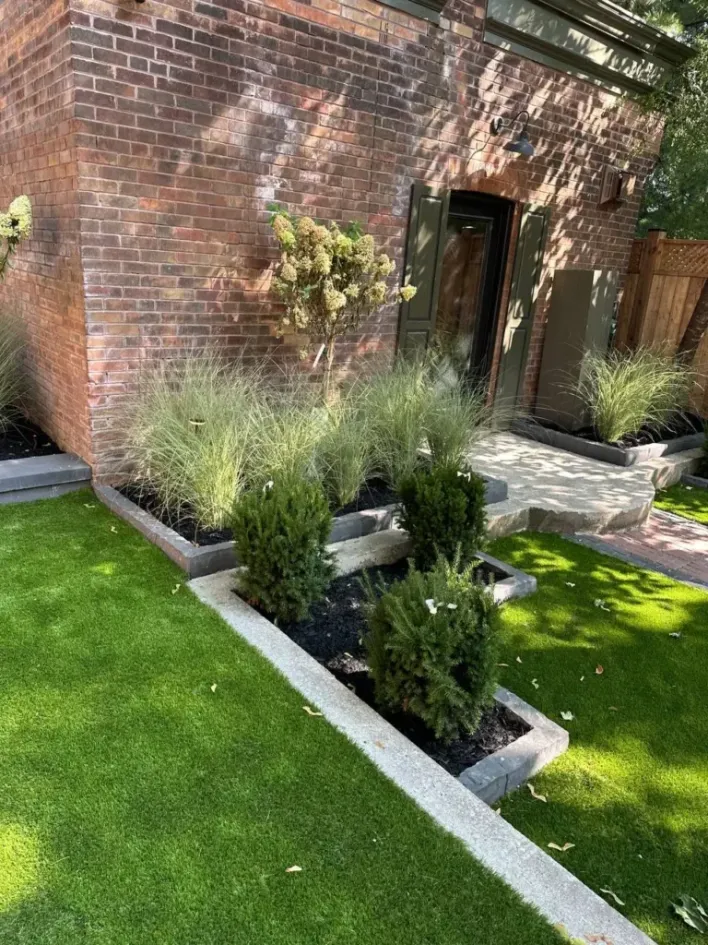 front yard landscape design with raised garden beds, shrubs, ornamental grasses and lawn edging