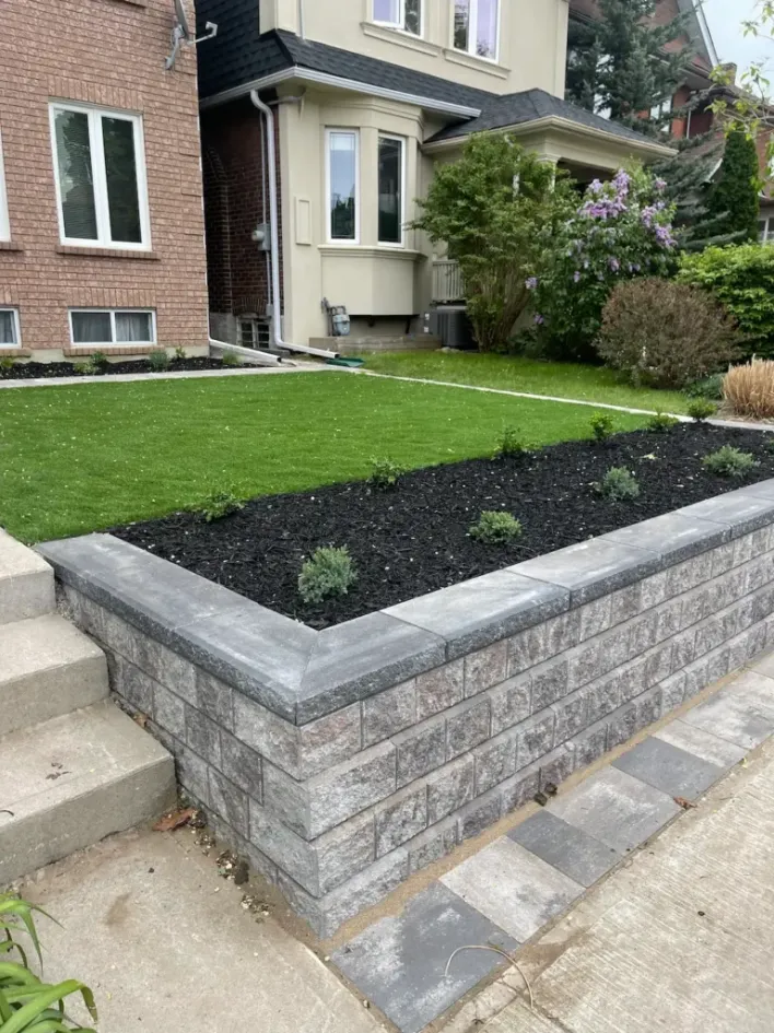 raised retaining wall with garden bed and lawn in front yard residential landscaping