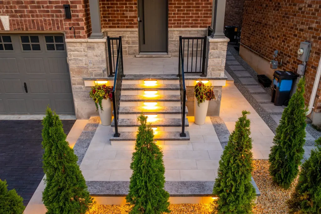 modern front porch with interlocking steps and built-in LED lighting with landscaped entryway