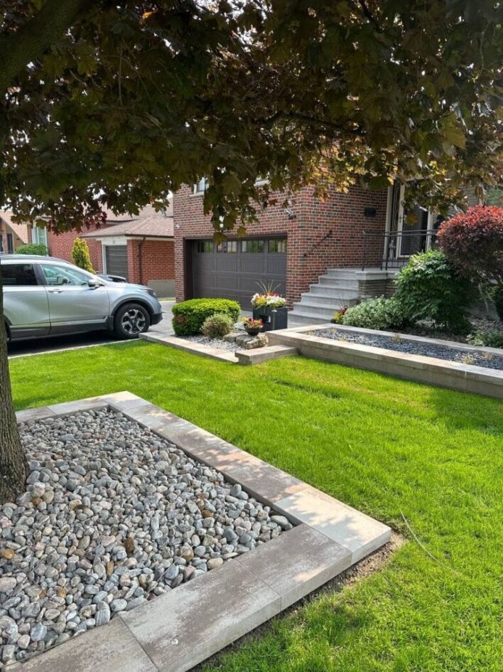 front yard landscaping with artificial grass, stone borders, gravel beds, and modern garden design near house entrance