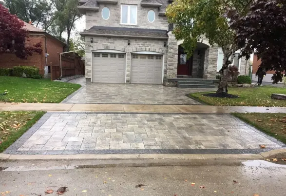 Interlocking stone driveway in front of a residential home, image by oakshs.ca