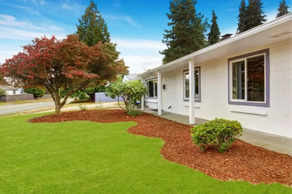 Landscape design by Oaks with front yard lawn and planting beds, image by OAKS Home Services