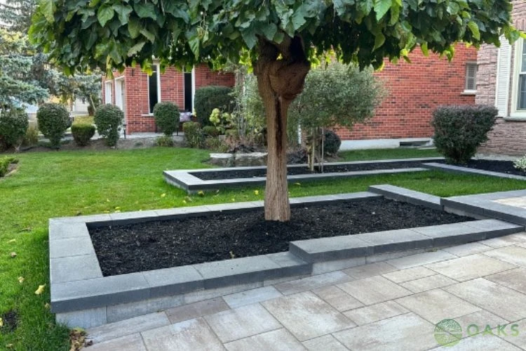Retaining wall garden bed with modern concrete blocks and interlocking stone patio design