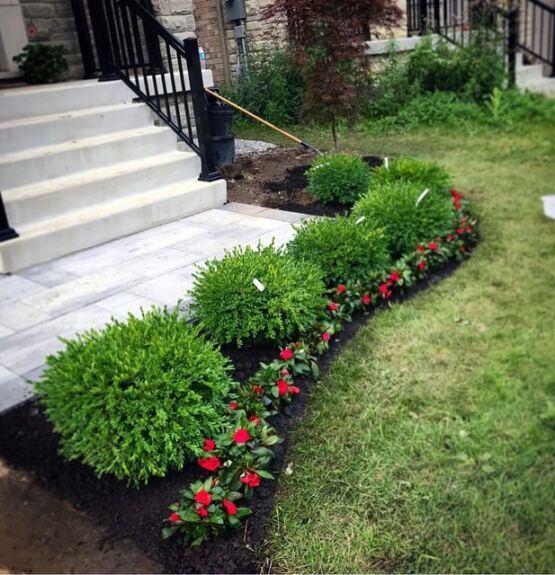 Landscape design with shrubs and flower bed along entry steps, image by oakshs.ca