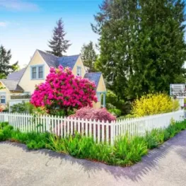 Landscape design with garden beds and decorative fencing, image by oakshs.ca