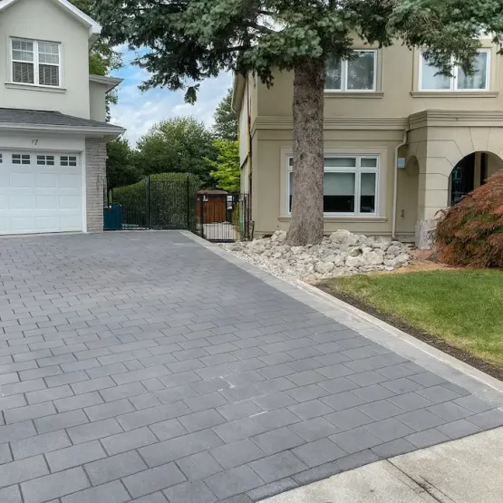 Modern interlocking stone driveway extension with gray pavers, image by oakshs.ca