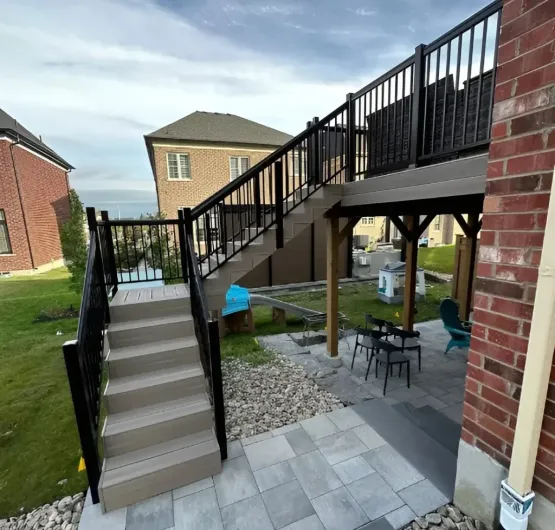 brand-new-deck-in-toronto-6 Two‑level deck with stairs and paved patio showcasing modern deck landscape design