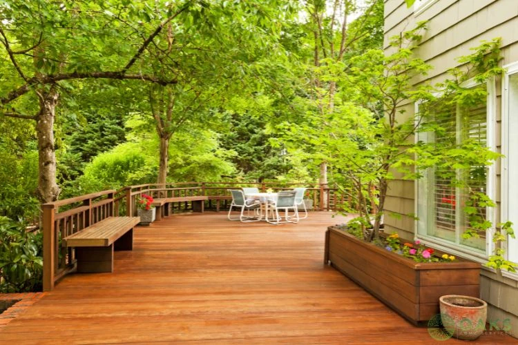 Custom wooden deck with built-in bench and planter boxes in landscaped backyard
