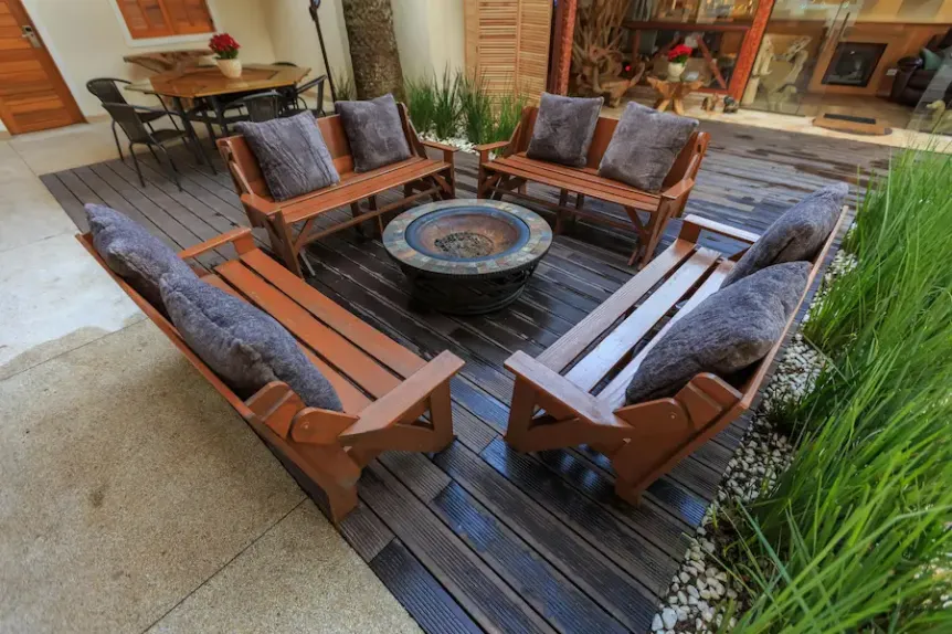 Cozy outdoor seating area with wood deck and central fire table