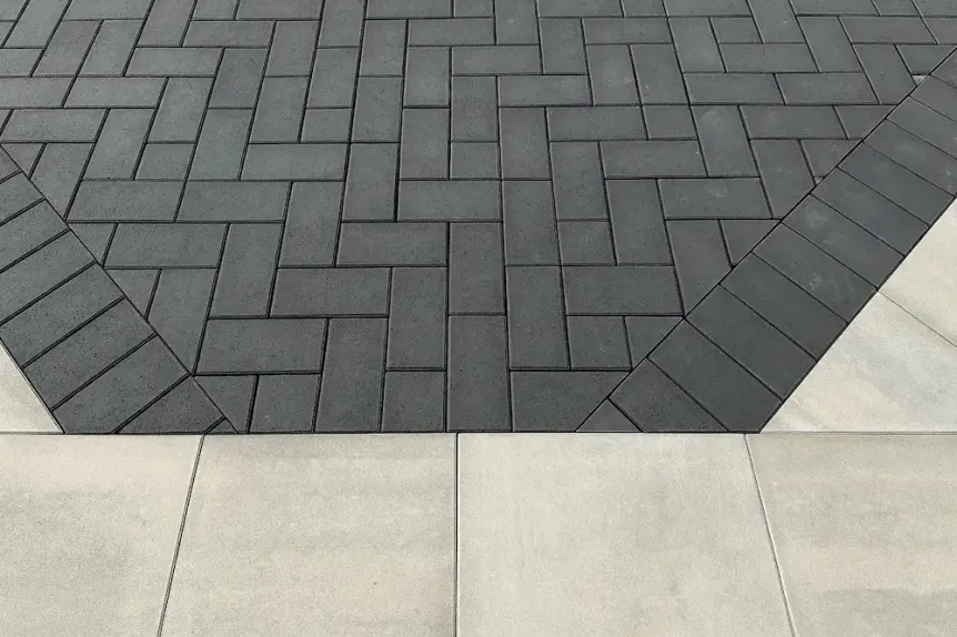 Dark gray herringbone paver pattern with contrasting border design