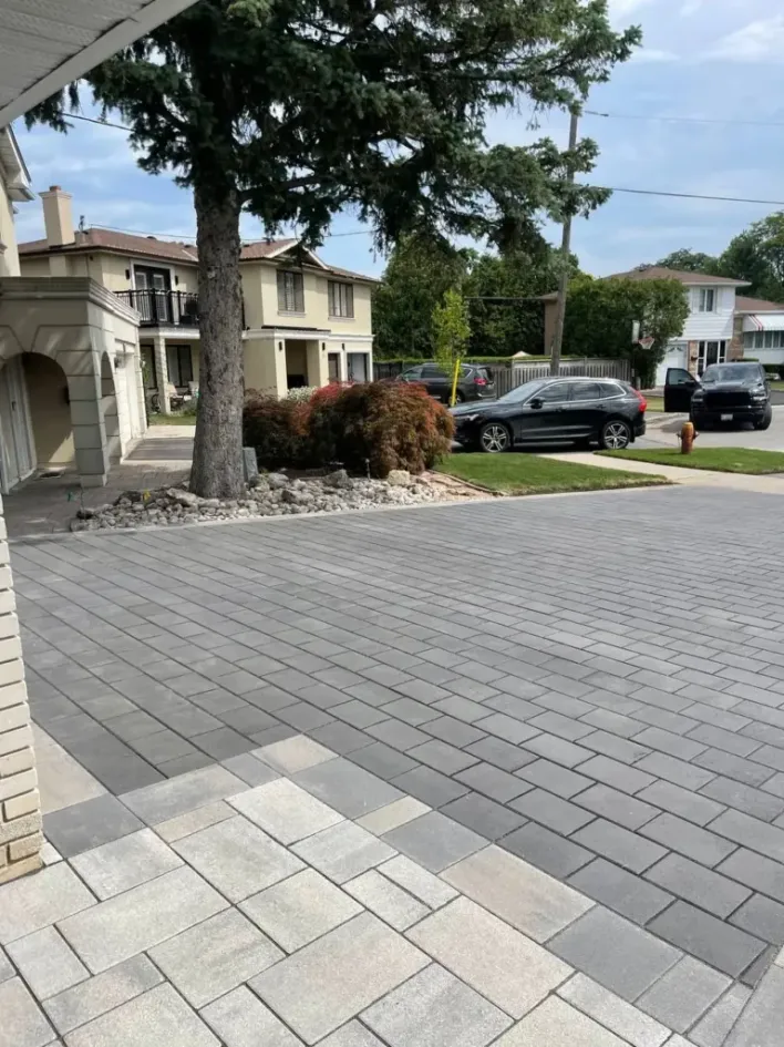 large driveway extension with interlocking pavers creating expanded parking space in front yard