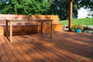 Custom built-in wooden deck bench and table in backyard outdoor space