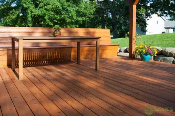 Custom built-in wooden deck bench and table in backyard outdoor space