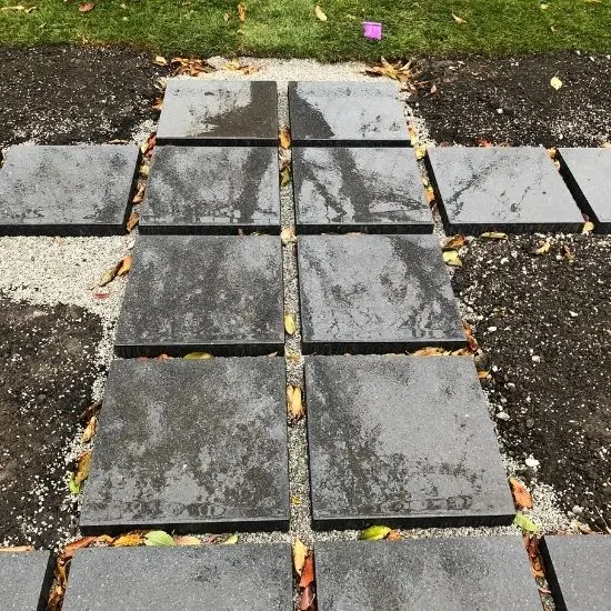 Concrete stepping stone pathway installation with square pavers set in gravel and soil for backyard landscaping design, image by OAKS Home Services