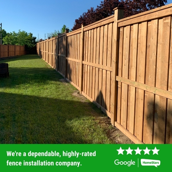 New wood fence installed in a backyard.