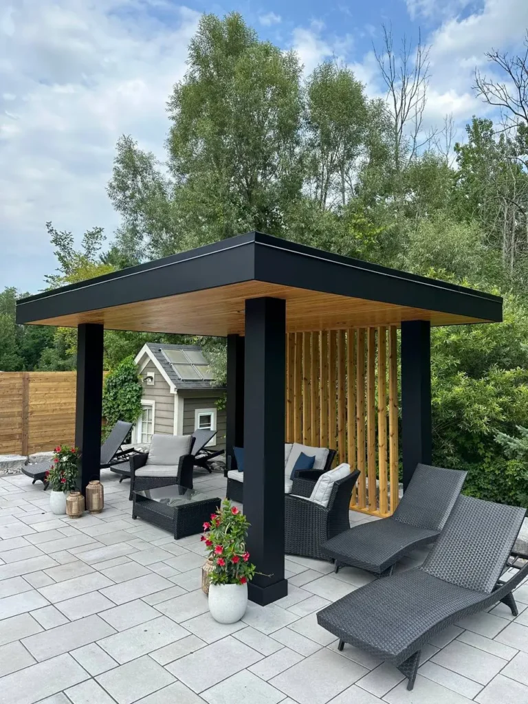 modern backyard patio with black pergola pavilion, lounge chairs and seating area