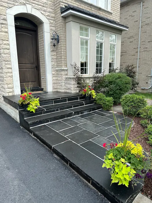 Stone front porch with dark slate steps by porch contractors, image by oakshs.ca