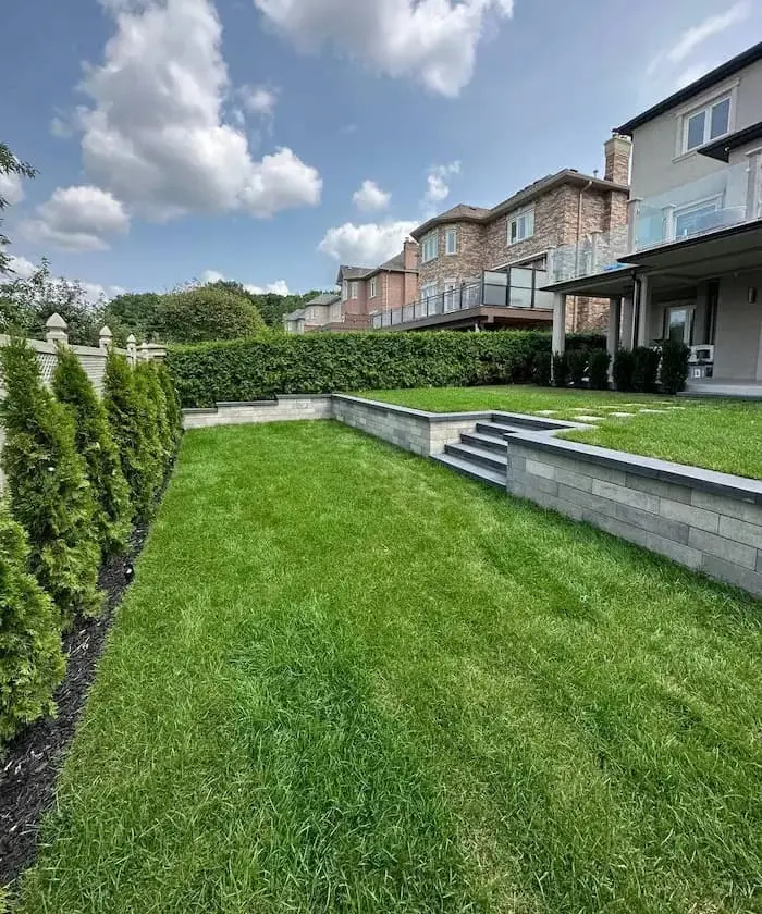 Landscape design with lawn and retaining walls in Ajax, image by OAKS Home Services