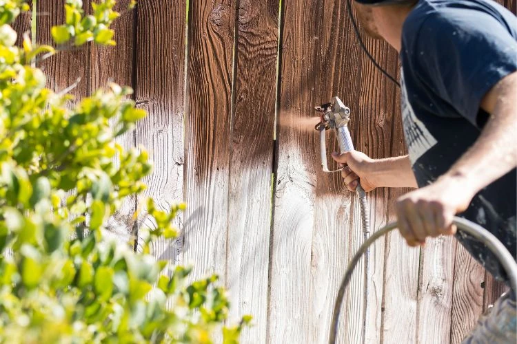 Fence staining and sealing process on wooden privacy fence panel