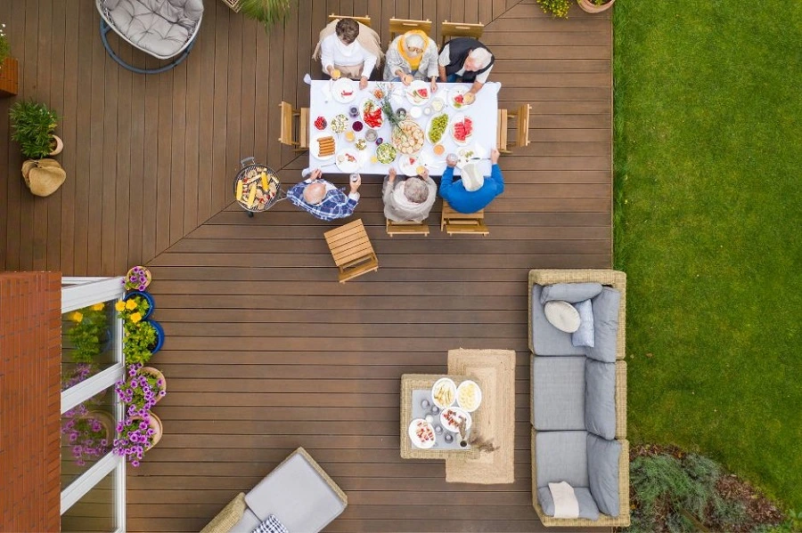 A modern wooden deck on the back of a suburban home, with clean lines and built‑in steps, photo by OAKS