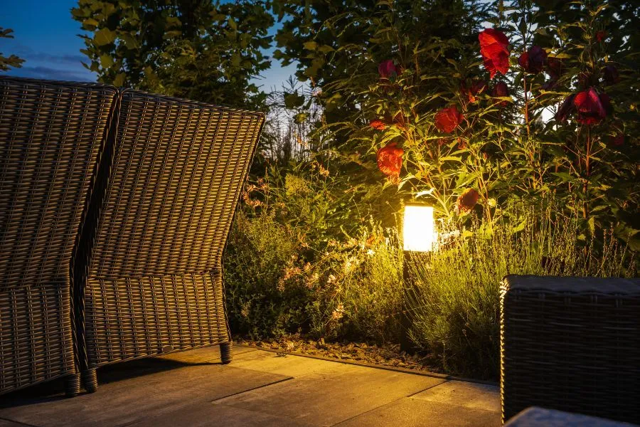 Landscape design with outdoor lighting and garden seating, image by OAKS Home Services